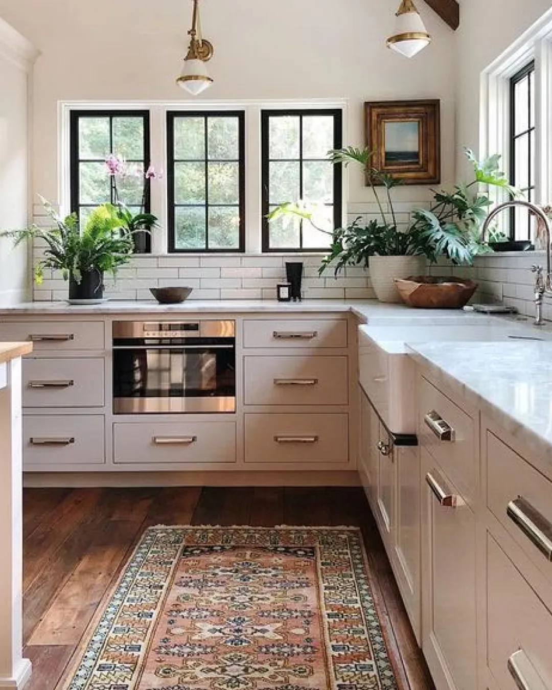 Light-filled kitchen with polished counters, cabinets, and appliances